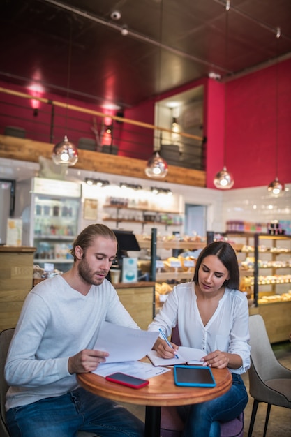 Young woman and man working in a small restaurant