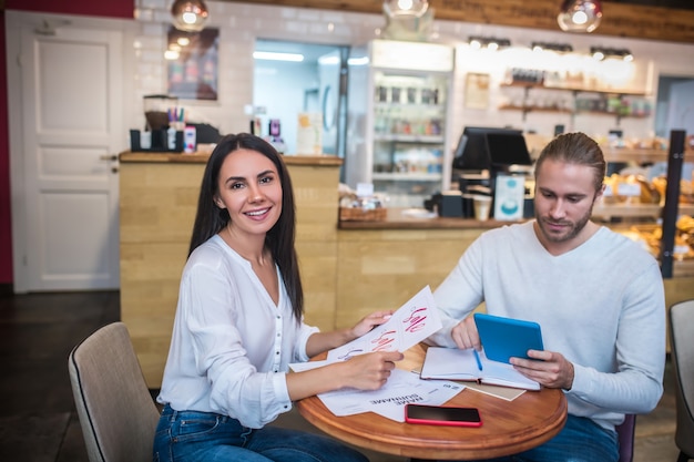 Young woman and man working in a small restaurant