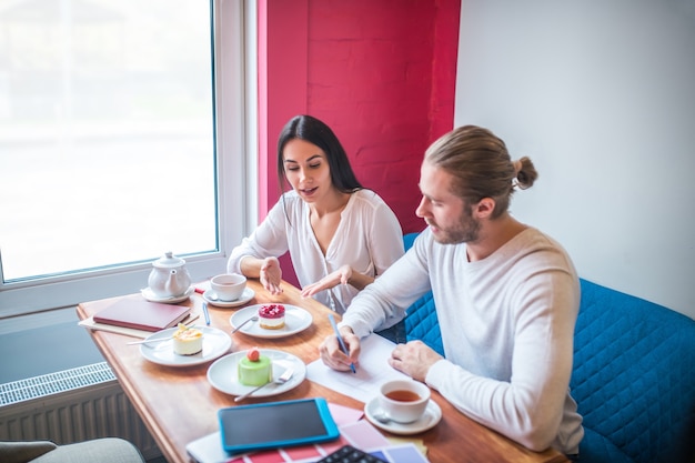 Young woman and man working in a small restaurant