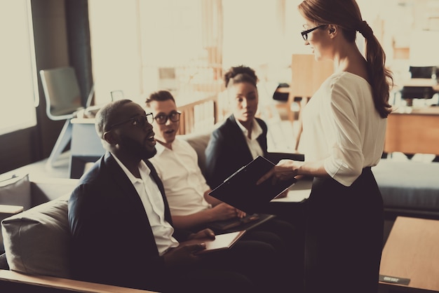 Young Woman Manager Explains Business Idea To Team.