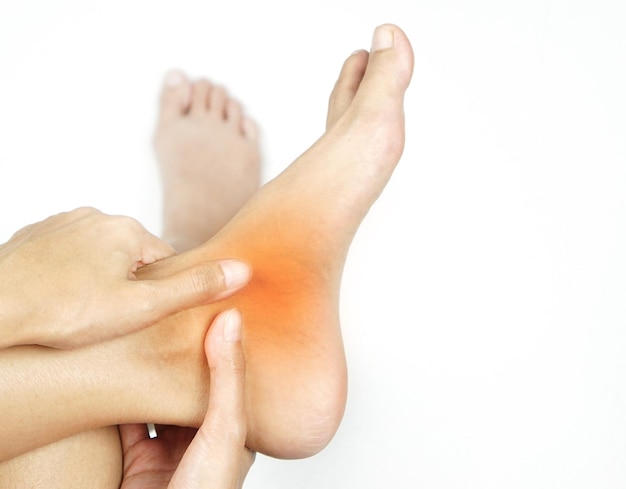 A young woman massaging her painful ankleSoft focus