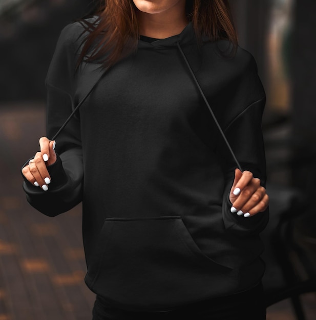 Young woman model wearing black women's hoodie mockup for your own design Street style photo