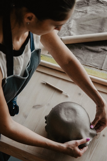 Young woman modeling clay