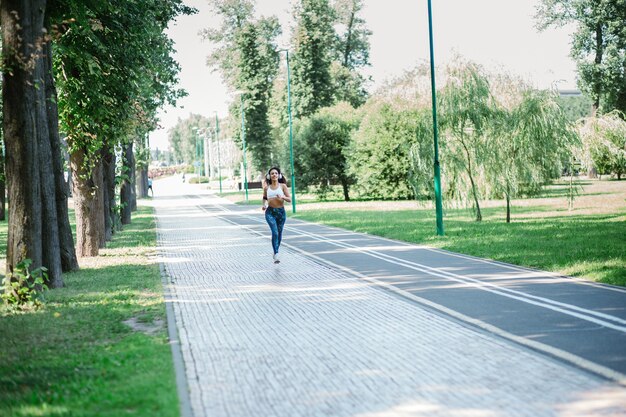 Young woman on a morning jog in a city park