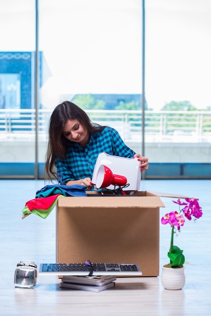 Young woman moving personal belongings