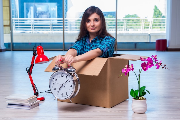 Young woman moving personal belongings