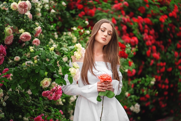 Young woman near the flowering bush