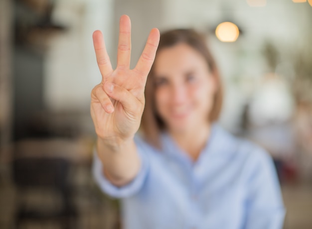 young woman number sign against company background