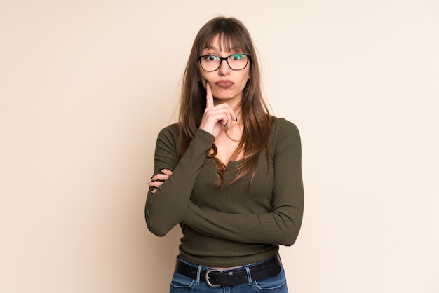 Young woman on ocher background Looking front