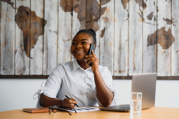 Young woman in office talking on the phone