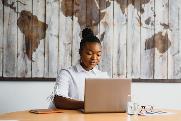 Young woman in office working on a laptop