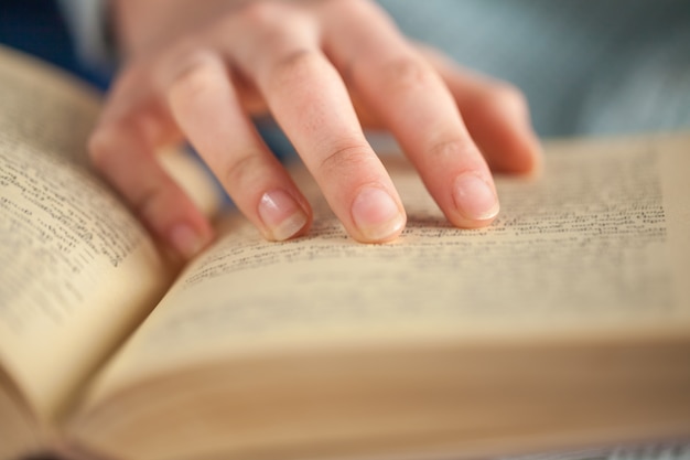 Young woman opening and reading a book