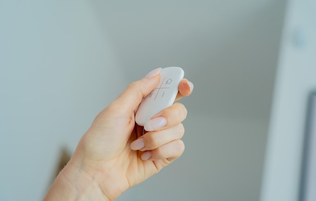 Young woman operates wireless security system in a modern apartment