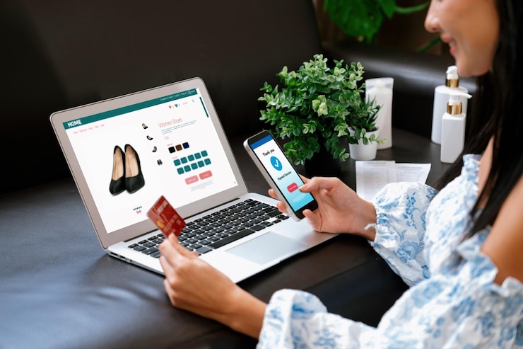 Photo young woman order or purchase product on internet using laptop blithe