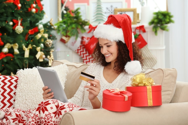 Young woman ordering Christmas gifts online