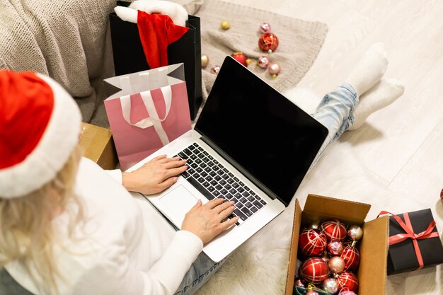 Young woman ordering Christmas gifts online