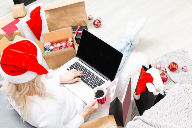 Young woman ordering Christmas gifts online