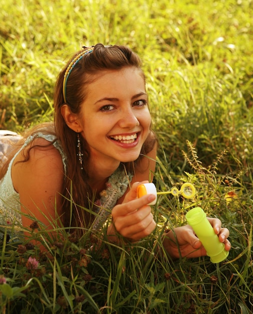 Young woman outdoor in the grass in summertime