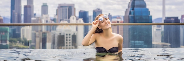 Young woman in outdoor swimming pool with city view in blue sky rich people banner long format