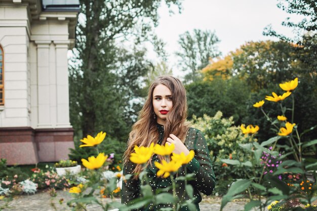 Young woman outdoors in flowers garden