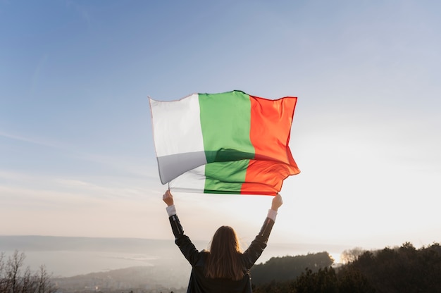 Young woman outdoors holding the bulgarian flag