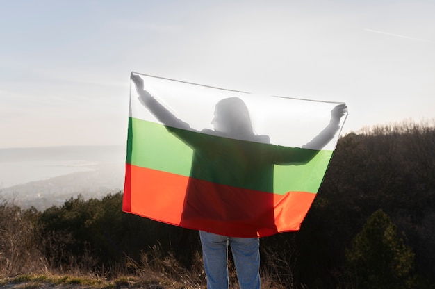 Young woman outdoors holding the bulgarian flag