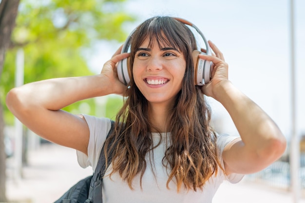 Young woman at outdoors listening music