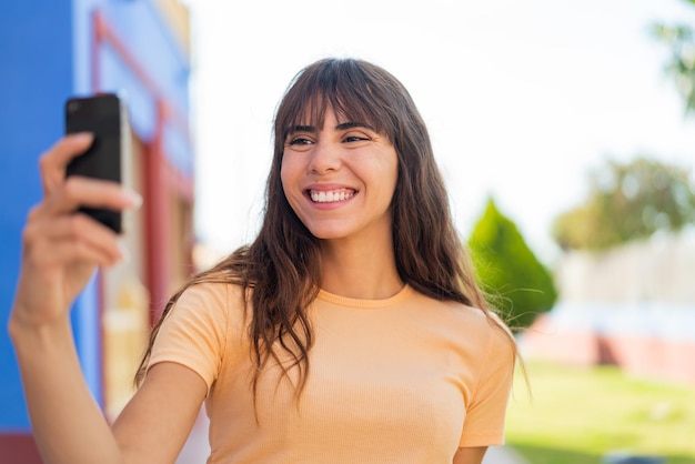 Young woman at outdoors making a selfie