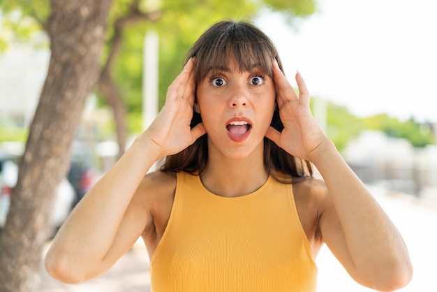 Young woman at outdoors with surprise expression