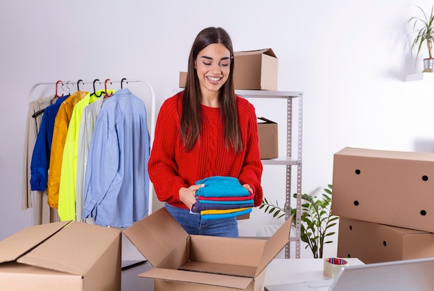 Young woman owener of small business packing product in boxes\
preparing it for delivery women packing package with her products\
that she selling online