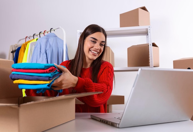 Young woman owener of small business packing product in boxes
preparing it for delivery women packing package with her products
that she selling online