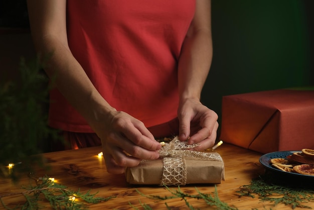 Young woman packages Christmas gift