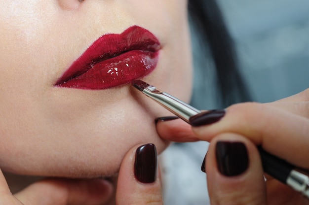 Photo young woman painted lips lipstick makeup close up