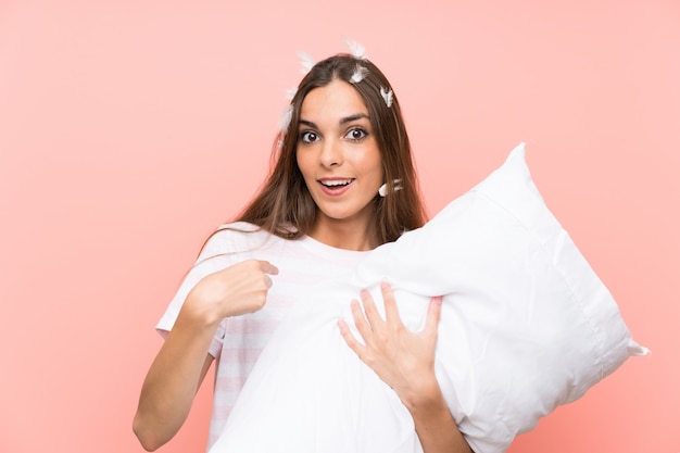 Young woman in pajamas with surprise facial expression