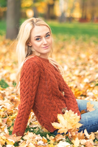 Young woman in park on autumn day