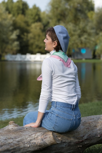 Young woman in the park. Cute girl portrait in french style.