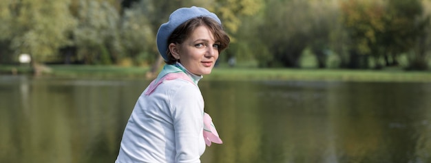 Young woman in the park Cute girl portrait in french style