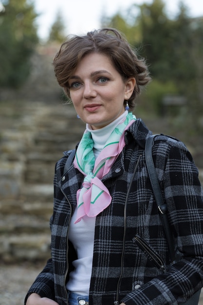 Young woman in the park. Cute girl portrait in french style.