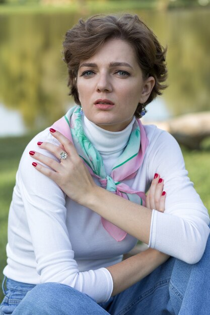 Young woman in the park. Cute girl portrait in french style.