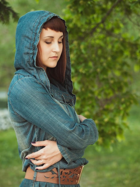 Young woman in the park  looking down