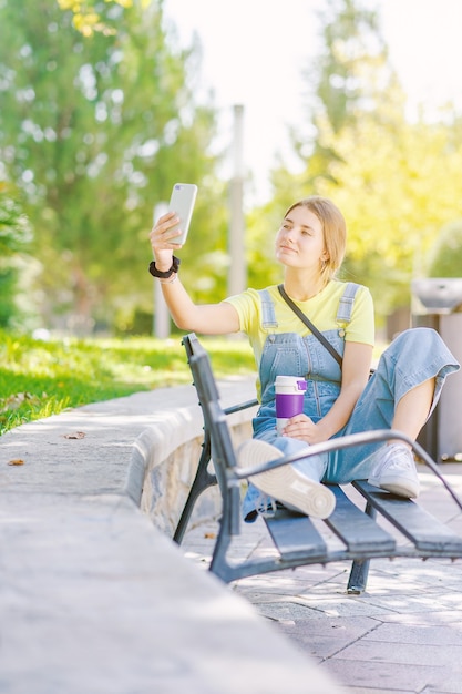 Young woman in the park taking a selfie