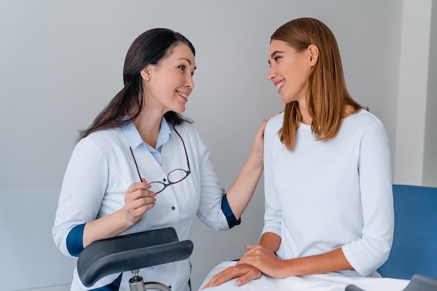 Young woman patient with gynecologist during consultation in doctor's office