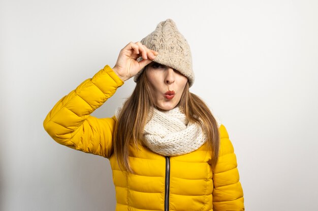 Photo young woman peeks out from under a hat isolated