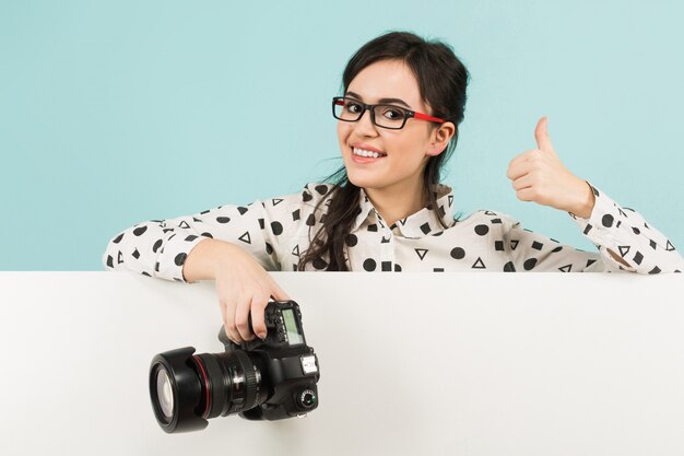 Young woman photographer with camera