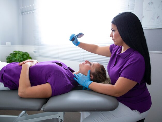 young woman in physical therapy with physiotherapist