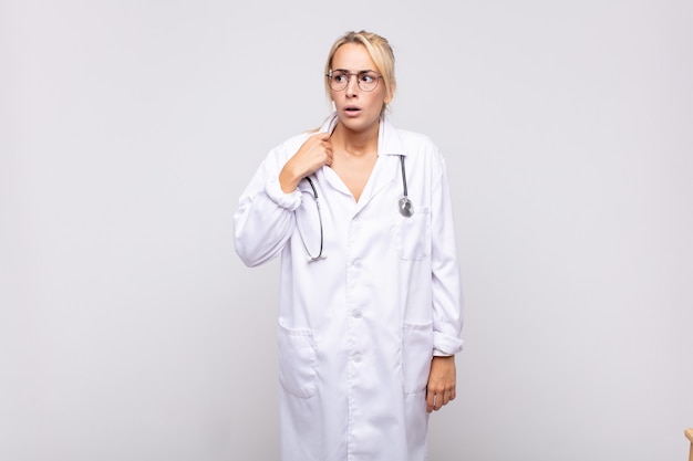 Young woman physician feeling stressed, anxious, tired and frustrated, pulling shirt neck, looking frustrated with problem