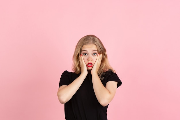 Young woman on pink background, copyspace