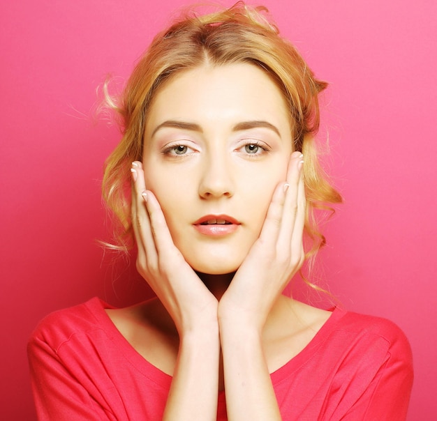 Young woman over pink background