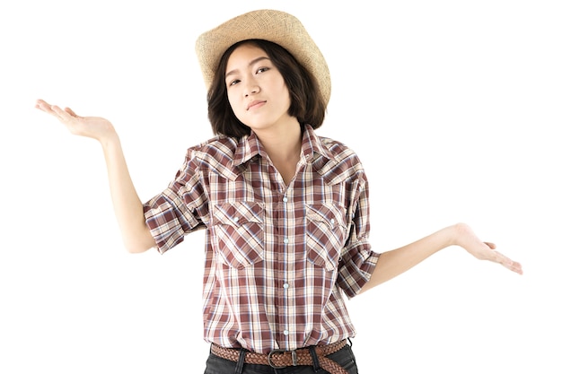 Young woman in a plaid shirt posing in studio on white background