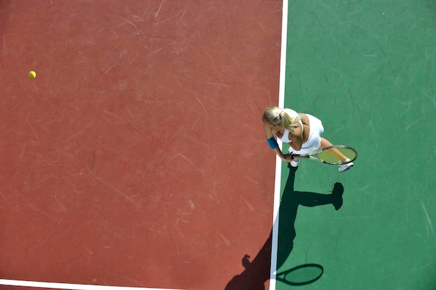 young woman play tennis outdoor